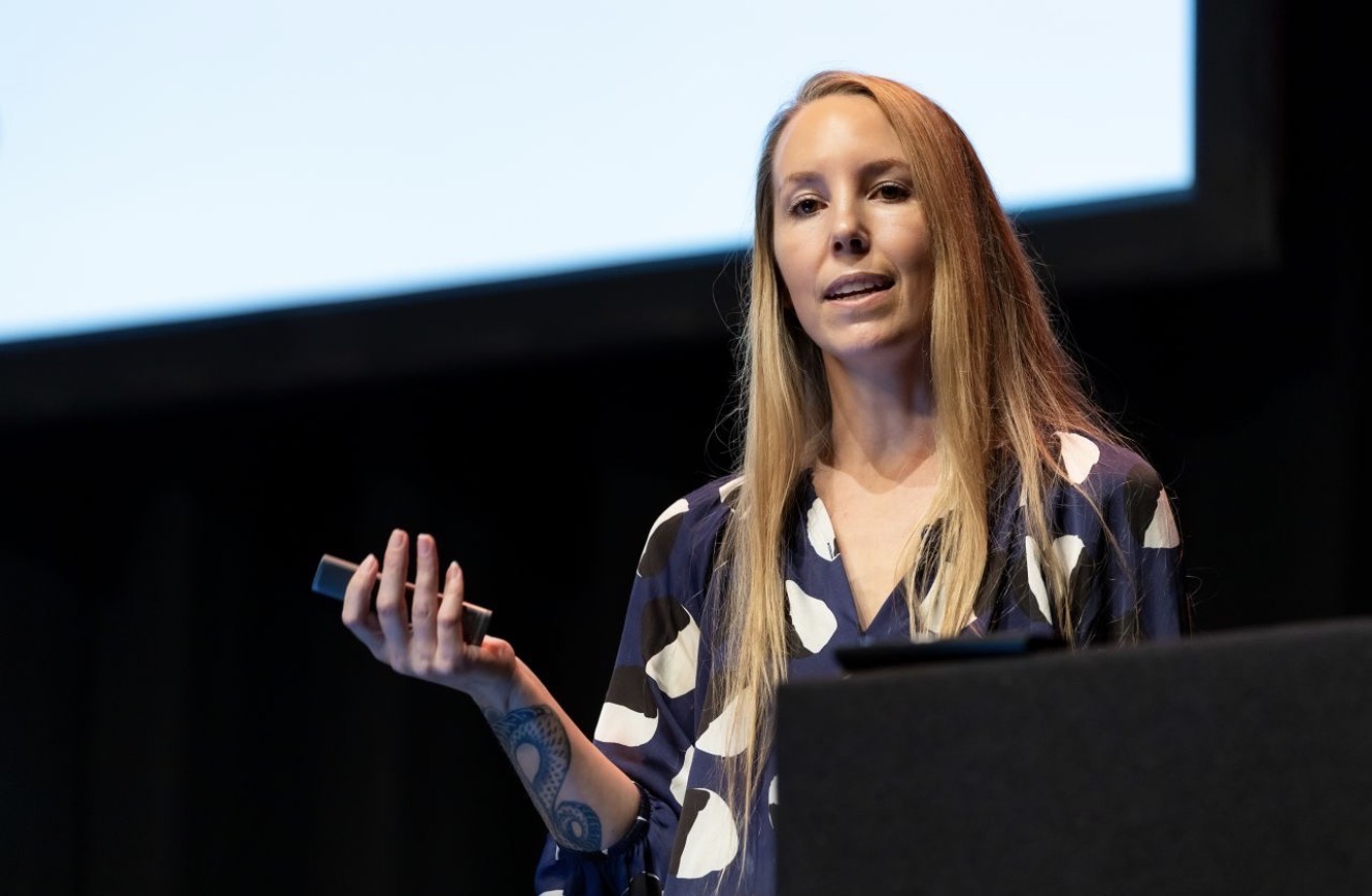 Kelly Dern at a podium